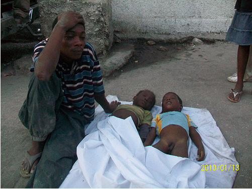 Man sits outside Médecins Sans Frontières (MSF) the day after Haiti's earthquake. "God gives them and God takes them away," he said. (Photo by Vladimir Leguerre